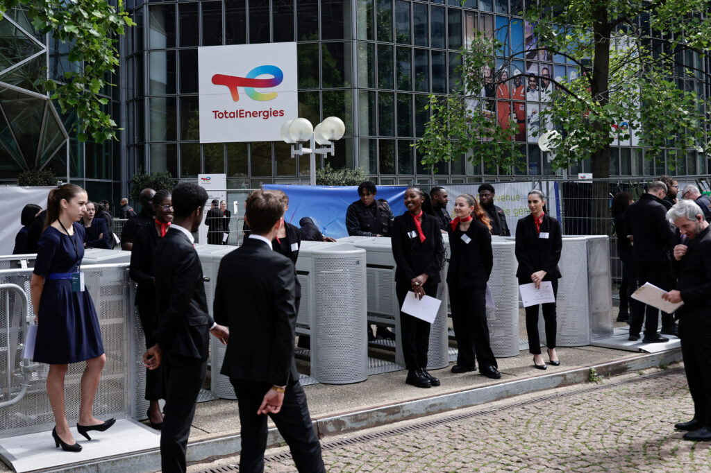 Shareholders enter the gates of the headquarters' of French oil and gas company TotalEnergies in Courbevoie, France on May 24. Credit: Stephane De Sakutin/AFP via Getty Images